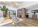 Cozy living room features a fireplace, vaulted ceiling, and lots of natural light at 1051 S Highland St # 7D, Mount Dora, FL 32757