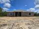 Rear exterior view of new home construction featuring block walls and view of the backyard at 12258 Sw 76 Ln, Dunnellon, FL 34432