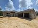 Front exterior view of a modern home under construction with a three-car garage at 12258 Sw 76 Ln, Dunnellon, FL 34432
