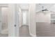 Hallway featuring gray vinyl flooring, a glass door, and an adjacent bathroom at 12258 Sw 76 Ln, Dunnellon, FL 34432