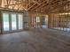 Interior view of the new home showing the living room framing and the back yard at 12258 Sw 76 Ln, Dunnellon, FL 34432