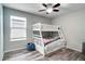 Cozy bedroom with bunk beds, wood-look floors, and natural light from the window at 14460 Orchard Hills Blvd, Winter Garden, FL 34787