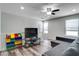 Bonus room with a ceiling fan, wood-look flooring, and a gray sofa at 14460 Orchard Hills Blvd, Winter Garden, FL 34787
