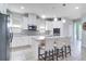 Modern kitchen with white cabinets, stainless steel appliances, and a center island with bar seating at 14460 Orchard Hills Blvd, Winter Garden, FL 34787