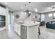 Bright kitchen with a large island, stainless steel appliances, and open layout to the living room at 14460 Orchard Hills Blvd, Winter Garden, FL 34787