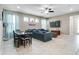 Comfortable living room and dining area with a large TV, tile floors, and open layout at 14460 Orchard Hills Blvd, Winter Garden, FL 34787