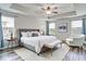 Spacious main bedroom with tray ceilings, a ceiling fan, hardwood floors and bright windows with a seating area at 14460 Orchard Hills Blvd, Winter Garden, FL 34787