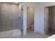 Modern bathroom featuring a glass-enclosed shower with tile and a separate toilet area at 14568 Crestavista Ave, Clermont, FL 34714