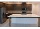 Spacious kitchen with a large island, stainless steel appliances, and sleek dark cabinetry at 14568 Crestavista Ave, Clermont, FL 34714