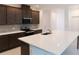 Bright kitchen boasting stainless steel appliances, dark cabinets, and a center island sink at 14568 Crestavista Ave, Clermont, FL 34714