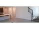 Open-concept living area featuring tile flooring and a staircase, with a view into the kitchen at 14568 Crestavista Ave, Clermont, FL 34714