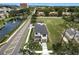 Aerial view of property showcasing home, surrounding community, street and pond at 1733 Harmon Ave, Winter Park, FL 32789