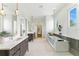 Spacious bathroom with double vanities, a soaking tub, and a glass shower at 1733 Harmon Ave, Winter Park, FL 32789