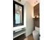 Modern half bathroom with unique pendant lighting and stylish wood paneling at 1733 Harmon Ave, Winter Park, FL 32789