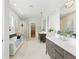 Elegant bathroom featuring double vanities, a large soaking tub, and a walk-in shower at 1733 Harmon Ave, Winter Park, FL 32789