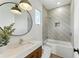 Modern bathroom featuring marble countertop, geometric tile shower and bathtub combo at 1733 Harmon Ave, Winter Park, FL 32789