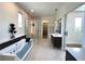 This bathroom features a soaking tub with clear glass side, a walk-in shower, and a dual sink vanity at 1733 Harmon Ave, Winter Park, FL 32789