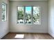Bright bedroom with views from the three windows overlooking mature trees at 1733 Harmon Ave, Winter Park, FL 32789