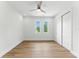 Minimalist bedroom with a ceiling fan and large sliding door closet at 1733 Harmon Ave, Winter Park, FL 32789