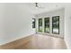 Bright bedroom with modern ceiling fan, hardwood floors, and multiple windows at 1733 Harmon Ave, Winter Park, FL 32789