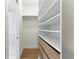 Walk-in closet with custom shelving and a glimpse of the glass shower at 1733 Harmon Ave, Winter Park, FL 32789