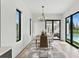 Elegant dining room with modern chandelier, glass table, and seamless access to the outdoor pool area at 1733 Harmon Ave, Winter Park, FL 32789