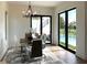 Elegant dining room with modern chandelier and view of the pool and outdoor area at 1733 Harmon Ave, Winter Park, FL 32789