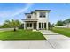 Modern two-story home with a well-manicured lawn, minimalist landscaping, and contrasting dark trim at 1733 Harmon Ave, Winter Park, FL 32789