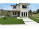 Contemporary home showcasing a crisp white facade, dark window frames, and minimalist landscaping at 1733 Harmon Ave, Winter Park, FL 32789