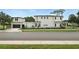 Modern home featuring sleek black trim, a detached garage, and minimalist landscaping along the fence at 1733 Harmon Ave, Winter Park, FL 32789