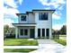 Modern two-story home boasting a clean white facade, black trim, manicured lawn, and contemporary landscaping at 1733 Harmon Ave, Winter Park, FL 32789
