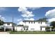 Modern home exterior featuring clean lines, white facade, and black trim, complemented by a lush green lawn at 1733 Harmon Ave, Winter Park, FL 32789