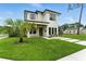 Modern two-story home with minimalist landscaping, a well-manicured lawn, and dark framed windows at 1733 Harmon Ave, Winter Park, FL 32789
