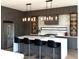 Modern kitchen featuring custom cabinetry, stainless steel appliances, and a large island with bar seating at 1733 Harmon Ave, Winter Park, FL 32789