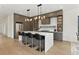 Modern kitchen features an island with seating, stainless steel appliances, and stylish lighting at 1733 Harmon Ave, Winter Park, FL 32789