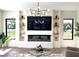 Bright living room featuring a fireplace, TV, built-in shelves and large windows for natural light at 1733 Harmon Ave, Winter Park, FL 32789
