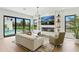 Bright living room with a modern fireplace, large windows, and outdoor pool views at 1733 Harmon Ave, Winter Park, FL 32789