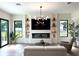 Stunning living room featuring hardwood floors, a modern fireplace, stylish decor, and large windows at 1733 Harmon Ave, Winter Park, FL 32789