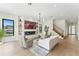 Bright living room with modern fireplace, stairs, and views of the outdoors at 1733 Harmon Ave, Winter Park, FL 32789