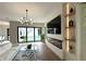 Bright living room with a modern fireplace, built-in shelves, and view of the backyard pool at 1733 Harmon Ave, Winter Park, FL 32789