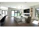 Open-concept living room featuring hardwood floors, modern fireplace, recessed lighting, and access to the pool at 1733 Harmon Ave, Winter Park, FL 32789