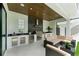 Outdoor kitchen and seating area with stainless steel appliances, grill, and wood ceiling at 1733 Harmon Ave, Winter Park, FL 32789