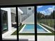 View of the modern backyard pool and outdoor seating area from inside the home at 1733 Harmon Ave, Winter Park, FL 32789
