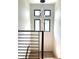 Modern staircase featuring a hanging light fixture and four windows offering natural light at 1733 Harmon Ave, Winter Park, FL 32789