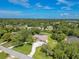 Aerial view showcasing the home's location nestled within a lush, wooded landscape at 1879 Odham Dr, Deltona, FL 32738