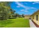 Well-manicured backyard featuring a shed, lush lawn, and mature landscaping at 1879 Odham Dr, Deltona, FL 32738