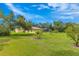 Spacious backyard features a lawn, shade trees, landscaping, and a pool at 1879 Odham Dr, Deltona, FL 32738