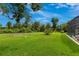 Expansive backyard featuring lush green grass and landscaping, offering plenty of room for outdoor activities at 1879 Odham Dr, Deltona, FL 32738