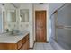 Bathroom with vanity, mirror, and tiled shower/tub combo at 1879 Odham Dr, Deltona, FL 32738