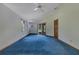 Cozy bedroom with blue carpet, sliding glass doors, and a ceiling fan at 1879 Odham Dr, Deltona, FL 32738